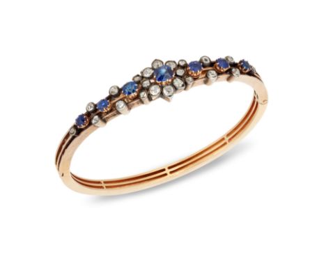 A 19th century French gold, sapphire and diamond bangle, the hinged half-hoop of openwork design, the central mixed cushion-c
