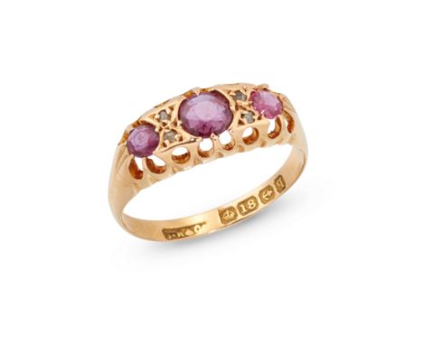 An early 20th century 18ct gold ruby and diamond ring,&nbsp;three graduated rubies with pairs of rose cut diamonds between, t