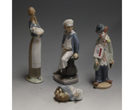 A Lladro figure of a young boy, in seated pose with pond yacht upon his lap, having printed mark and numbered 4810, h.23cm; t
