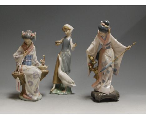 A Lladro figurine of Japonesa Serenidad, boxed; together with one other Lladro figure of a Geisha girl and a Lladro girl with