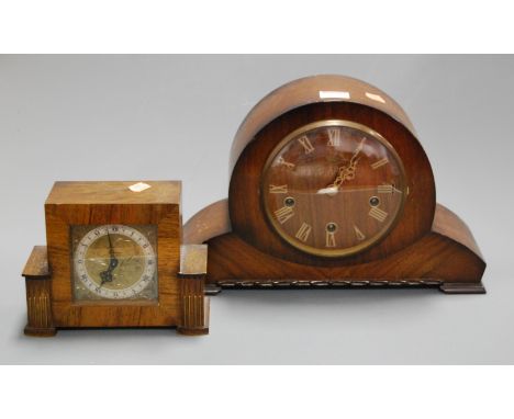A 1950s oak cased Smiths mantel clock together with one other walnut cased example (2). Oak clock with key.Both have chips an