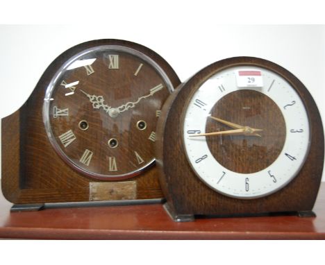 A 1950s Smiths oak cased mantel clock, having raised Roman numerals and eight day movement; together with one other Smiths oa