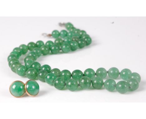 A beaded and knotted green jade necklace, with silver clasp, 44cm; together with a pair of cabochon jade ear studs