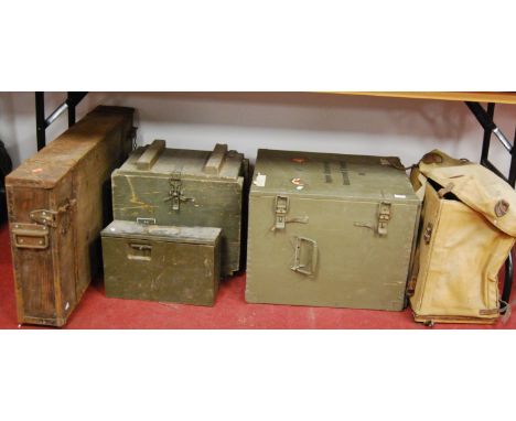 A collection of various military containers to include ammunition crates, canvas backpack etc