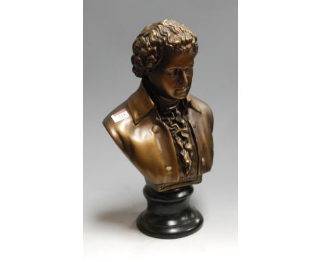 A reproduction bronzed plaster portrait bust of Mozart, on a socle base, h.44cm