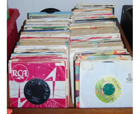 A box of assorted 7" vinyl single records dating mostly from the 50s and 60s to include Rolling Stones etc. Most are in sleev