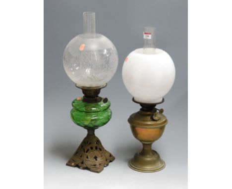 A Victorian oil lamp, having etched globular shade to a green glass font and pierced brass base; together with one other bras