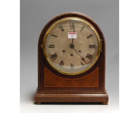A 1920s mahogany cased dome-top mantel clock, having a silvered dial with Roman numerals, eight day movement striking on a go