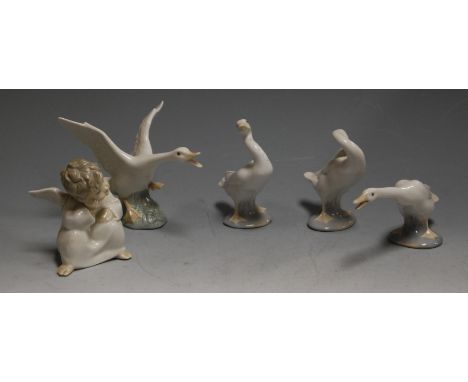A Lladro porcelain figure of a cherub in seated pose, printed mark verso, h.10cm; together with various Lladro porcelain gees