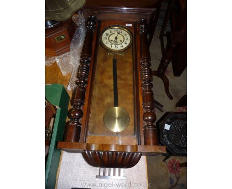 A large wall Clock with plastic film face with Arabic numerals, pendulum, key and finial, 54'' tall (a/f)