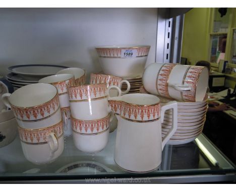 A pink and white ground Teaset with gilt border comprising twelve cups, saucers and side plates, milk jug, sugar bowl and two