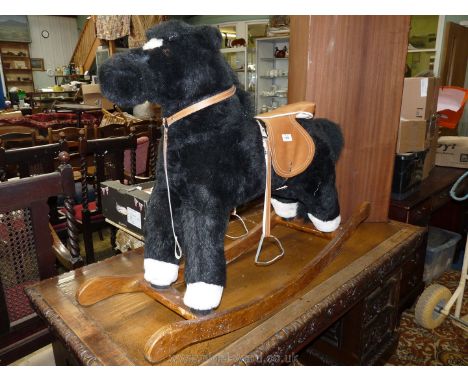 A black Mammas &amp; Papas rocking horse