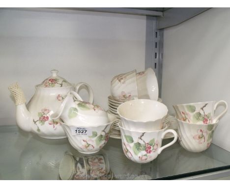 A Wedgwood 'Apple Blossom' Teaset for six with large bread and butter plate, teapot, milk jug and sugar basin.