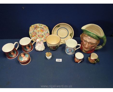 A box of china to include a large Toby jug of Scrooge, Beswick ware, commemorative cups, Dartmouth pottery cup/saucers etc.