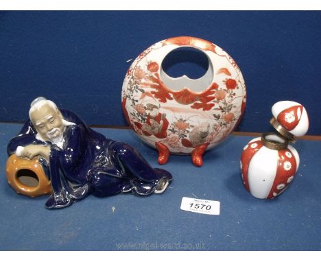 A Kutani footed basket Vase, an oriental ceramic figure of an old man reclining against a barrel and a six sided red and whit