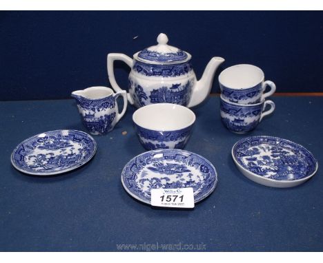 A Staffordshire blue and white willow pattern children's part teaset to include; two cups and saucers, plate, jug, sugar bowl