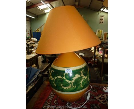 A medium orange and green Louis Drimmer table lamp and matching shade.