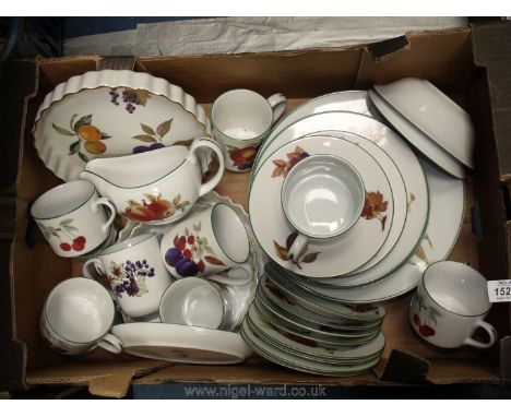 A quantity of Royal Worcester 'Evesham' including three flan dishes, plus Evesham Vale mugs, dinner plates, cups, saucers and