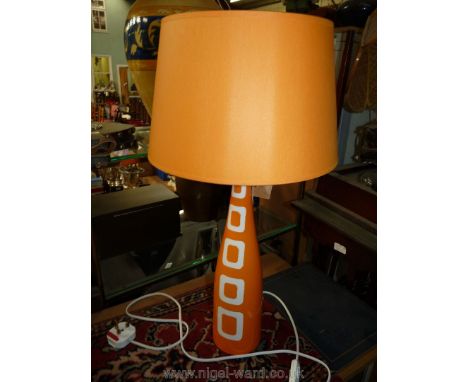 A tall, slim modern design Louis Drimmer orange table lamp and matching shade.