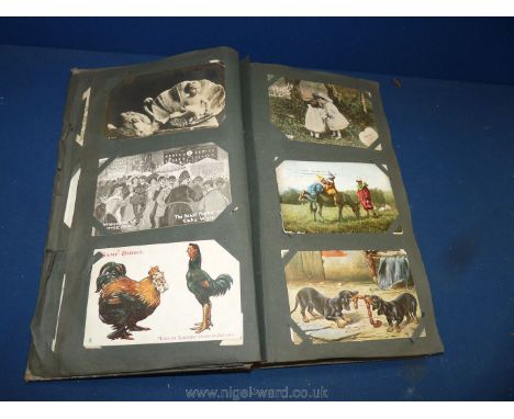 An old Postcard Album and contents including Louis Wain 'Cats Matrimony', Lunch at the Races and The Railway Station postcard