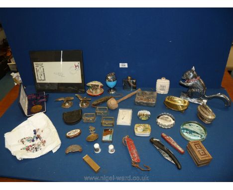 A box of miscellanea to include squirrel nut cracker, lighters, oriental shell, small flask, penknives, Volvo medal etc.