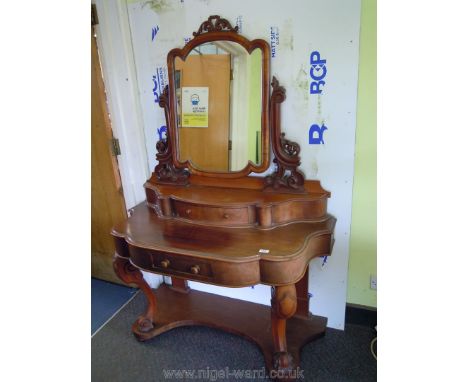 A Victorian Mahogany Duchess type Dressing Table having swing mirror on carved and fretworked supports with bow fronted trink