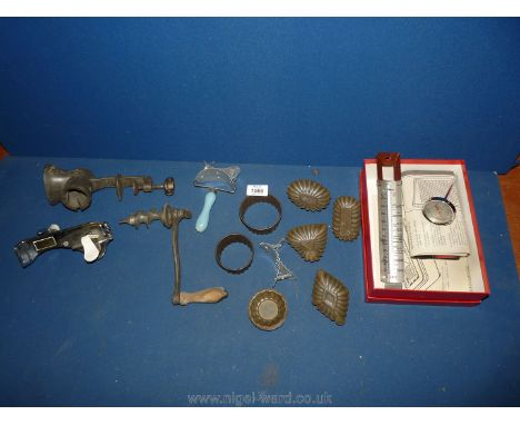 A vintage mincer, pate tins, thermometer etc