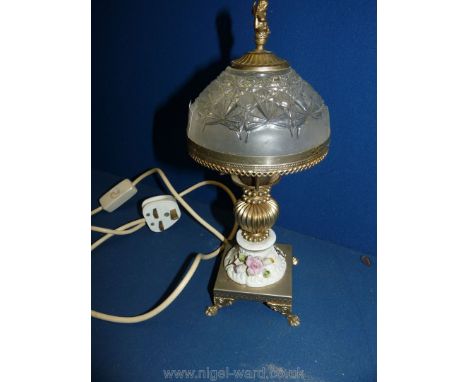 A small ceramic table lamp with metal base and frosted glass shade with cherub finial, 11'' tall