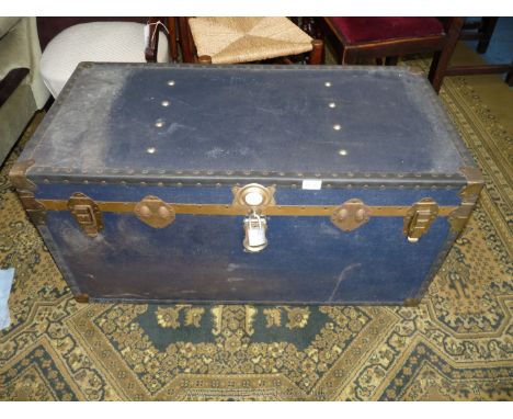 A large dark blue Trunk with brass corners and studs, 39 1/2'' long x 20'' deep x 19 3/4'' wide.  