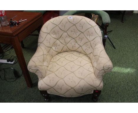 Low Upholstered button back chair on turned supports 