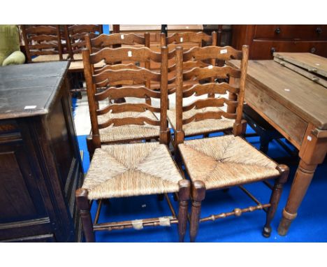 A set of four traditional shaped ladder back kitchen chairs having rush seats
Beading missing from side of chair and some bea
