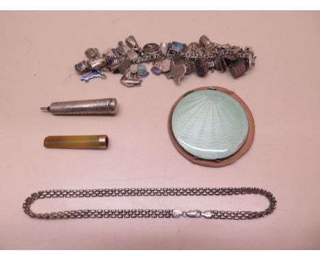 A silver charm bracelet, a silver chain, a silver compact and a cheroot holder with 9ct band in a silver case, weighable silv