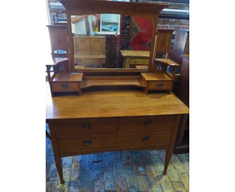 An Art Nouveau Oak Liberty style dressing table Rgd No&nbsp; 380496 with stylized inlay and heart shaped handles having two t