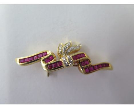 An 18ct yellow gold diamond and ruby brooch approx 4.5 grams, marked 750, 3.6 cm long, in good condition 