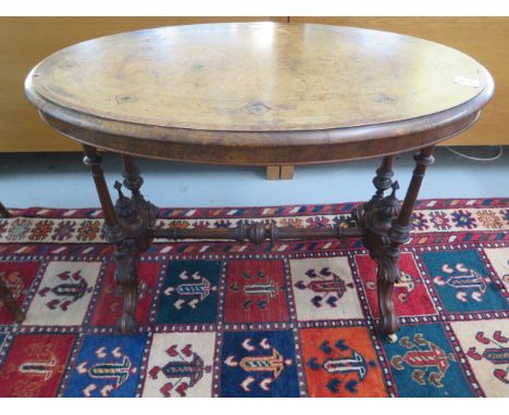 A Victorian inlaid stretcher table on turned pillar supports, 70cm tall x 99cm x 55cm, some losses and wear consistent with a