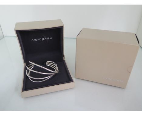 A Georg Jensen sterling silver Alliance bangle, 7.5cm wide external, boxed and in good condition, approx 48 grams 
