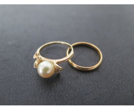 A 22ct band ring, size K, approx 2 grams, a14ct yellow gold pearl ring, size J, approx 2.5 grams 