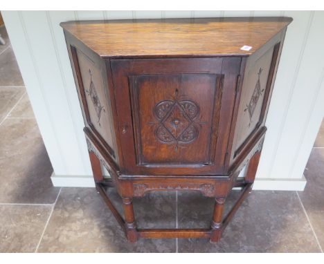 A carved oak cupboard with a single door, back panel missing, 79cm wide 