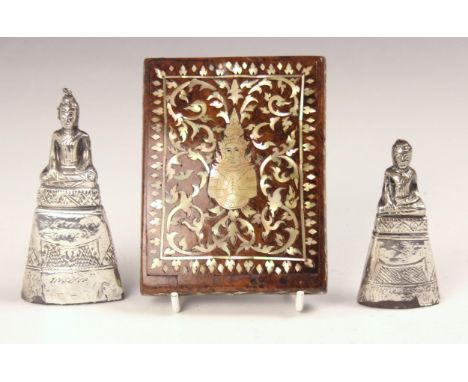 A white metal mounted Burmese figure of a deity, with engraved detail, 10cm high, with a further smaller example, 8cm high, a