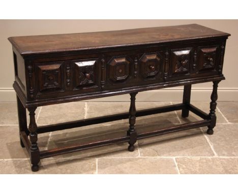 A Jacobean style oak sideboard, 17th century and later, the moulded plank top, over three frieze oak lined drawers, applied w