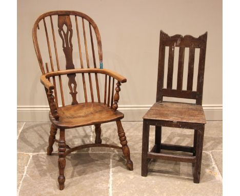 An early 19th century ash and elm Windsor chair, the hoop back with a central pierced splat over a shaped seat, upon bobbin a