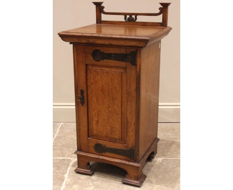 An Arts & Crafts oak pot cupboard, by Wylie and Lochhead, Glasgow, the open work top rail above a rectangular moulded top and