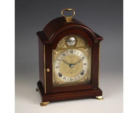 A mahogany cased Elliot mantel clock, retailed by Lowe and Sons, Chester, the arched case enclosing a gilt metal and silvered