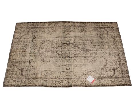 An Oka Haversham wool rug, in a green foliate design, 60% wool, 40% cotton, with retailers original label, 180cm x 270cmCondi