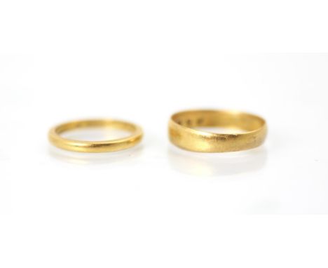 A 22ct yellow gold wedding band, stamped 'HA' Birmingham 1878, ring size M, with a further 22ct yellow gold wedding band, sta