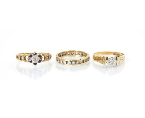 A selection of three yellow metal rings, including a 9ct diamond solitaire ring, the round cut diamond in white metal mount l