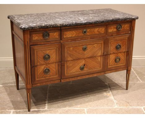 A French Louis XVI style walnut and kingwood marble top commode chest, late 19th century, the break front variegated marble t