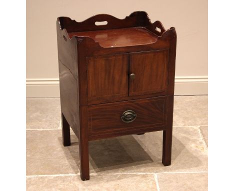 A George III mahogany tray top bedside chest, the galleried top above a pair of cupboard doors and a sliding commode, upon ch
