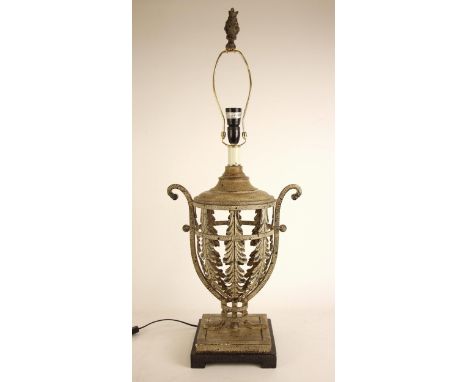 A continental metal table lamp base, of urn form, the body pierced throughout with foliate panels, twin handled, with foliate