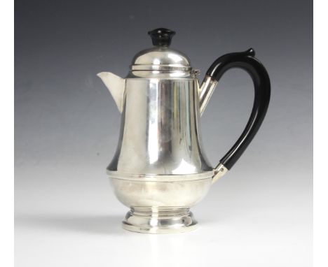 A silver hot water jug, Aaron Lufkin Dennison Birmingham 1935, of tapering cylindrical form with ebonised handle and finial, 